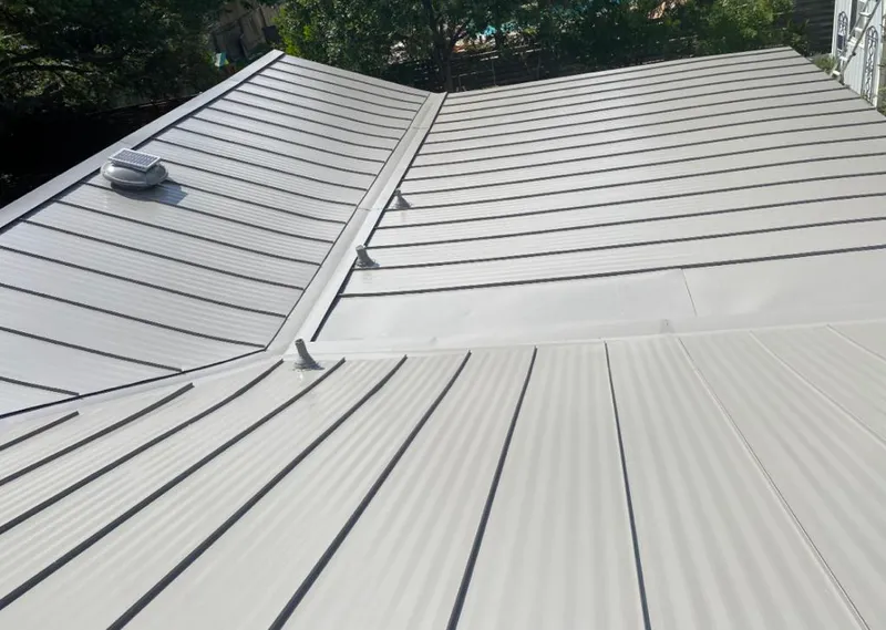Solar attic fan installed on a metal roof for Roof Ventilation in Gardiner